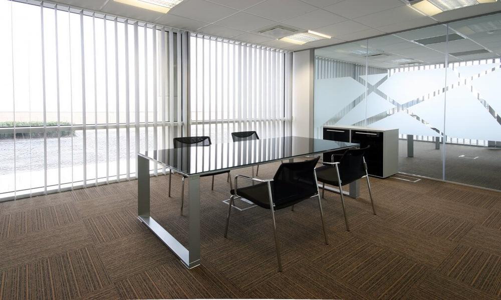 How do curtains affect the atmosphere of an office?
